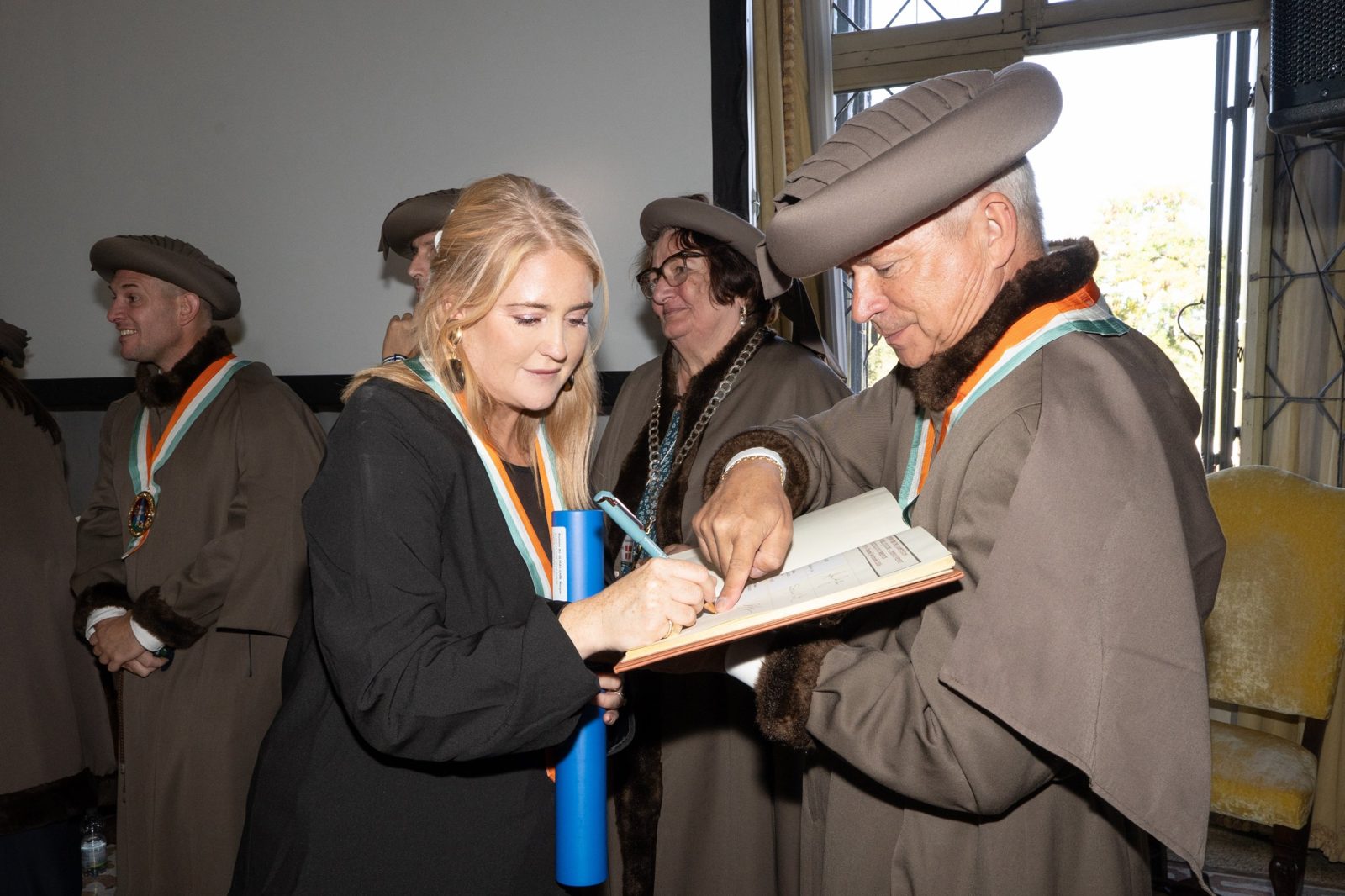 Morgan McGlynn Carr signing the Guilde Internationale des Fromagers register at her induction ceremony, Caseus 2026
